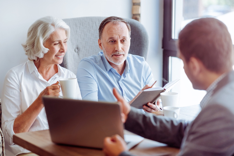 Couple consulting with insurance agent