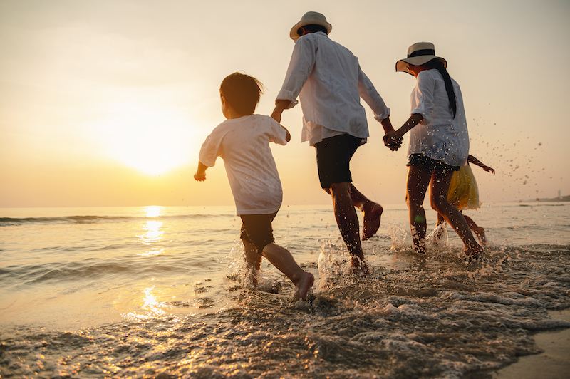 Family running on beach together