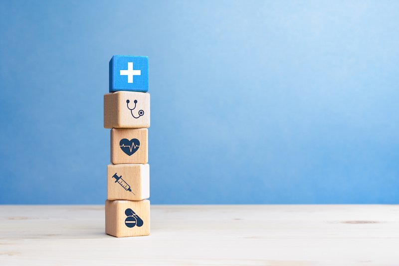 Health insurance concept, wooden blocks with healthcare medical icons