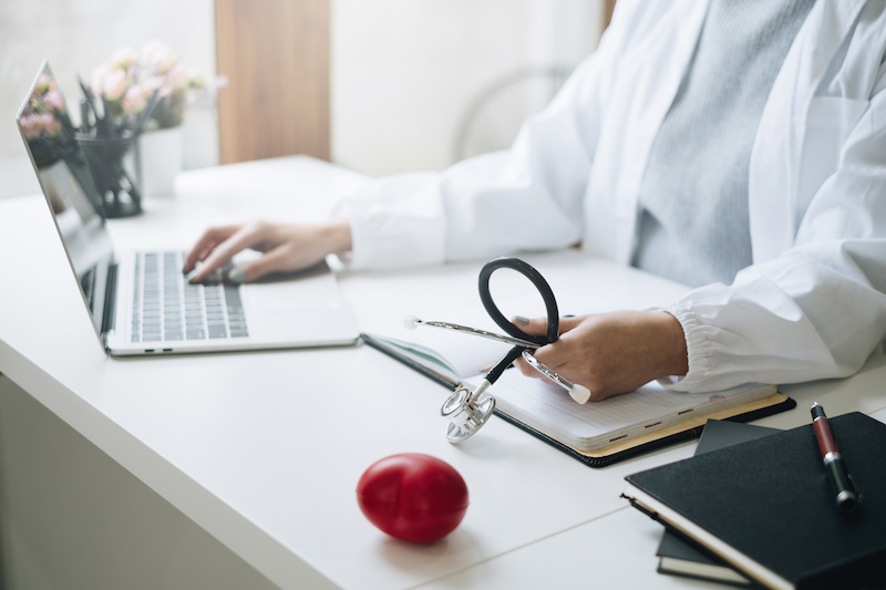 Portrait of doctor showing stethoscope tools at office in private clinic